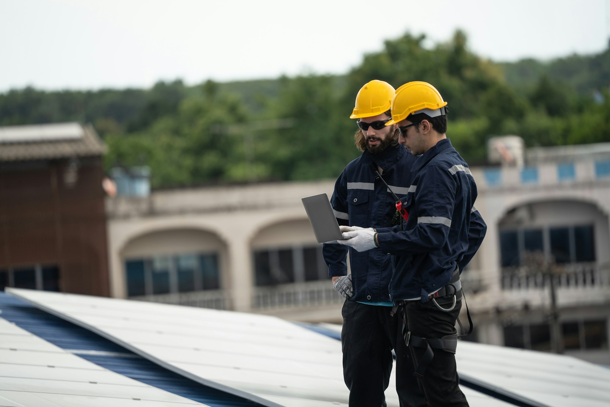 Engineer team checking solar cell on the roof of the factory