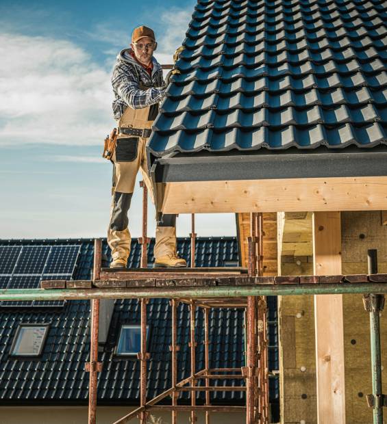 Construction Worker Performing Roof Installation