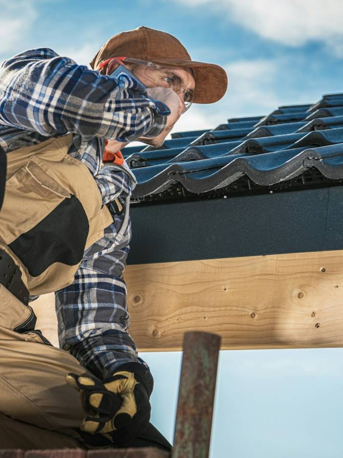 Roof Contractor Talking On Cell Phone.